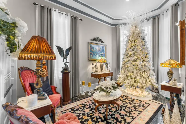 a living room with furniture and a chandelier