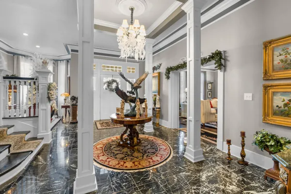 a very nice looking room with a large window and chandelier