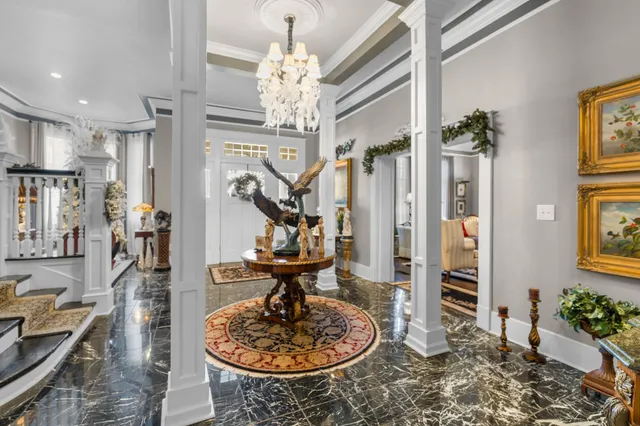 a very nice looking room with a large window and chandelier