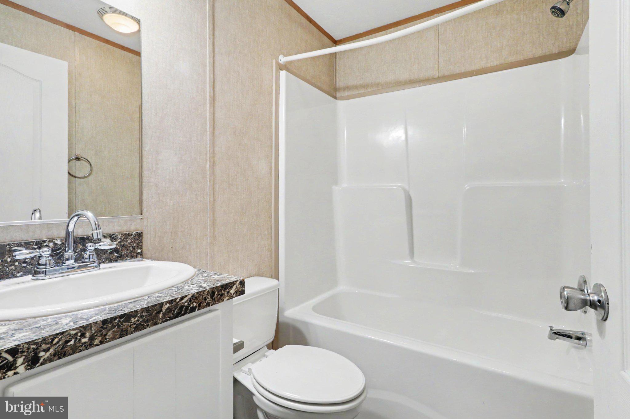 66 Kip Road Halifax, PA 17032 - Photo 12 of 16 a bathroom with a granite countertop sink mirror toilet and bathtub