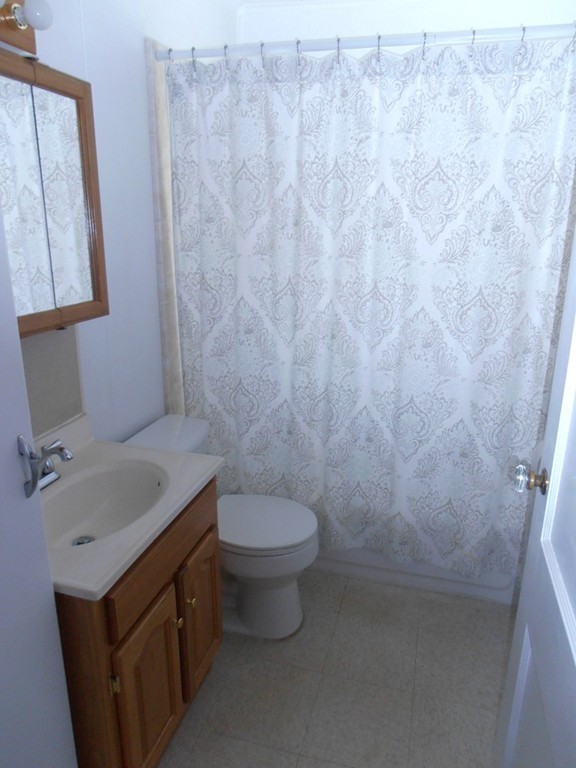 57 Ramah Street Springfield, MA 01104 - Photo 8 of 17 a bathroom with a granite countertop sink and a toilet