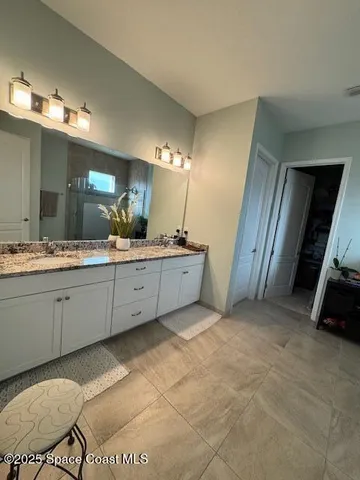 a bathroom with a sink double vanity and a mirror