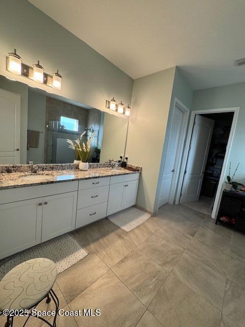2115 Trift Bridge Circle Melbourne, FL 32940 - Photo 11 of 34 a bathroom with a sink double vanity and a mirror
