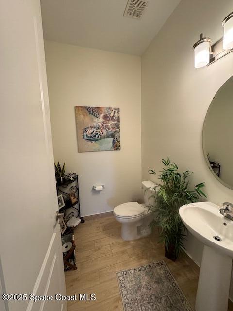 2115 Trift Bridge Circle Melbourne, FL 32940 - Photo 20 of 34 a bathroom with a toilet a sink and mirror
