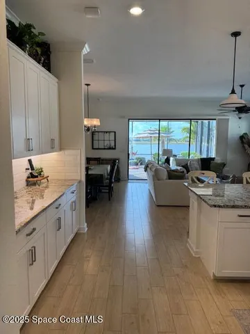 a kitchen with sink cabinets and wooden floor
