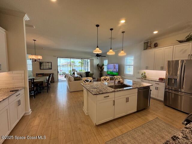 2115 Trift Bridge Circle Melbourne, FL 32940 - Photo 5 of 34 a kitchen with stainless steel appliances granite countertop a sink a stove and a refrigerator