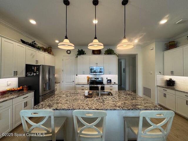 2115 Trift Bridge Circle Melbourne, FL 32940 - Photo 7 of 34 a kitchen with granite countertop counter space a sink and stainless steel appliances