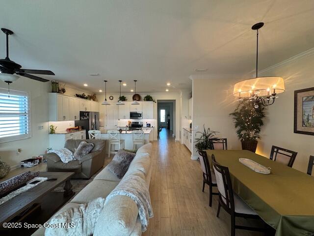 2115 Trift Bridge Circle Melbourne, FL 32940 - Photo 9 of 34 a view of a dining room and livingroom with furniture wooden floor a chandelier