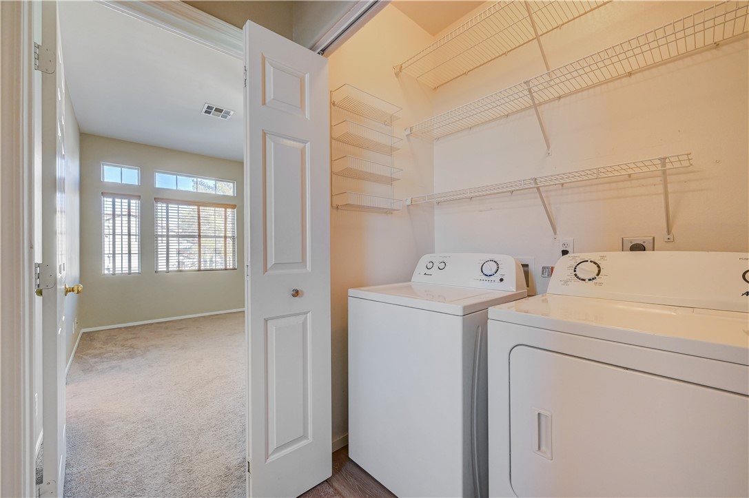2232 Ramsgate Drive Henderson, NV 89074 - Photo 10 of 19 A functional laundry space features wire shelving and convenient access to an adjacent carpeted room.
