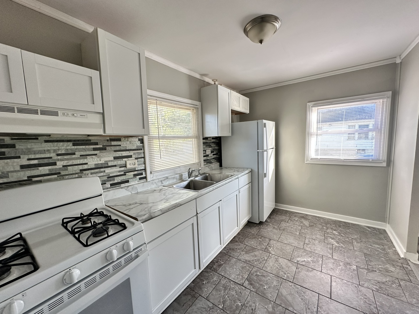 1061 Cottage Place Joliet, IL 60436 - Photo 11 of 21 a kitchen with stainless steel appliances a sink stove and refrigerator