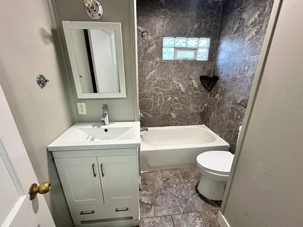 a bathroom with a sink toilet a mirror and shower