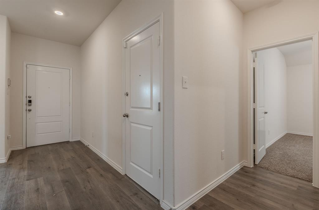 2902 Trusting Way Aubrey, TX 76227 - Photo 25 of 38 Entryway featuring wood-finish flooring, white trim, recessed lighting, and white panel doors with brushed nickel hardware