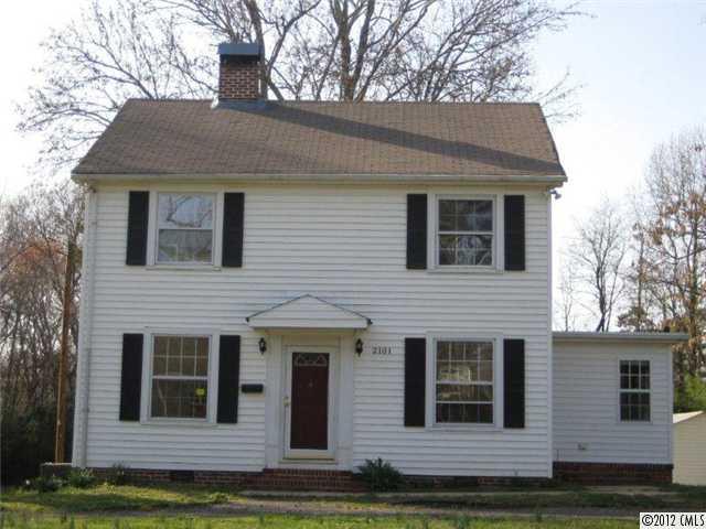 a view of house with yard