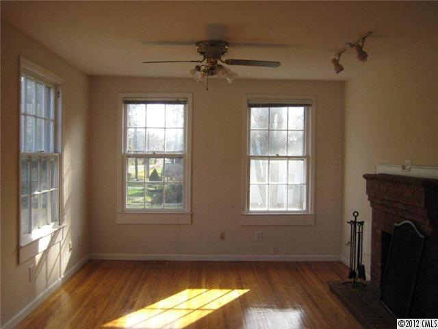 2101 Eaton Road Charlotte, NC 28205 - Photo 2 of 13 a view of an empty room with wooden floor and a window