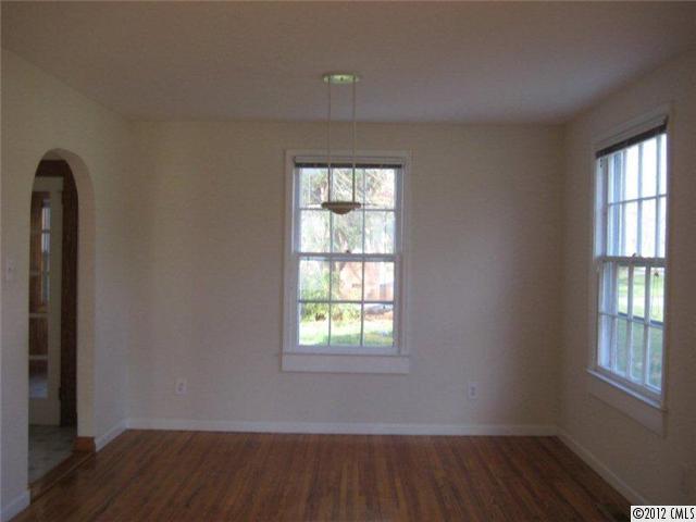 2101 Eaton Road Charlotte, NC 28205 - Photo 3 of 13 an empty room with wooden floor and windows