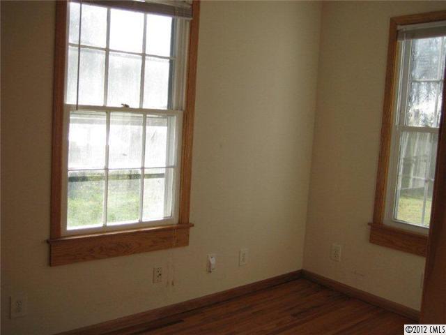 2101 Eaton Road Charlotte, NC 28205 - Photo 4 of 13 a view of an empty room with wooden floor and a window