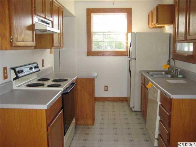 2101 Eaton Road Charlotte, NC 28205 - Photo 5 of 13 a kitchen that has a sink a stove and a refrigerator
