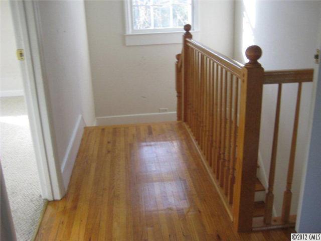 2101 Eaton Road Charlotte, NC 28205 - Photo 10 of 13 a view of a hallway with wooden floor and staircase