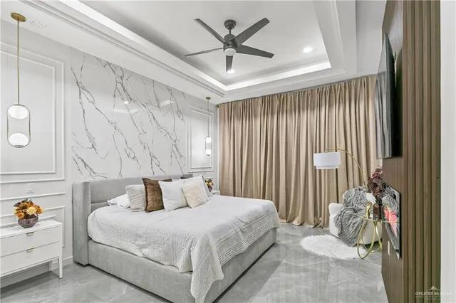 a bedroom with a bed and a chandelier