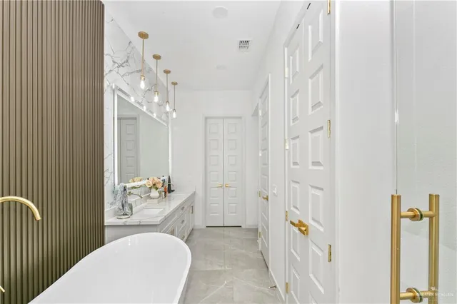 a kitchen that has a lot of cabinets a sink and appliances in it