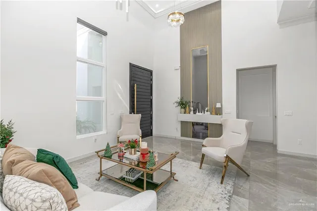 a dining room with furniture a kitchen view and a chandelier