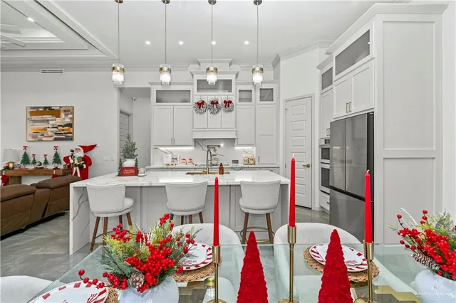 a kitchen with kitchen island a sink stove and refrigerator