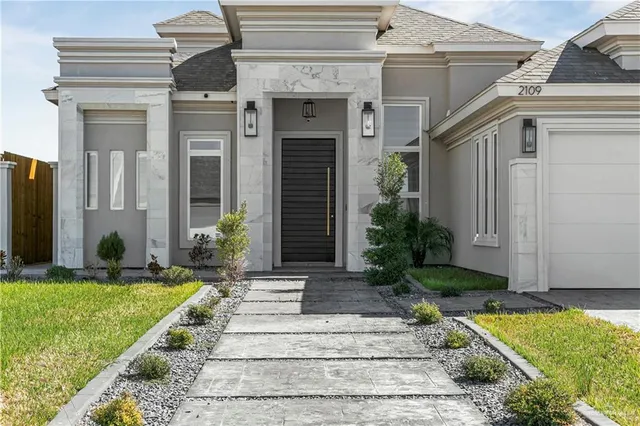 a front view of a house with garden