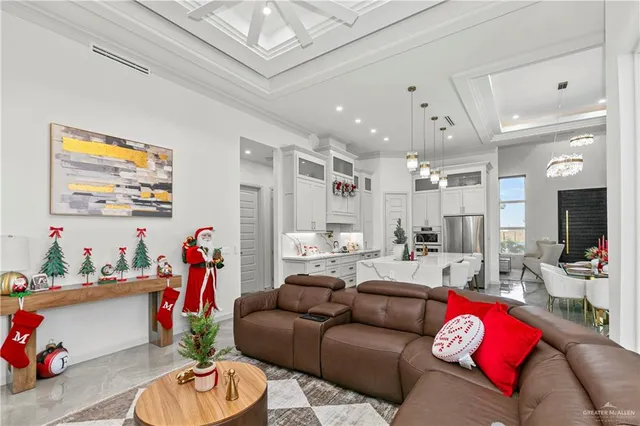 a living room with furniture and a chandelier