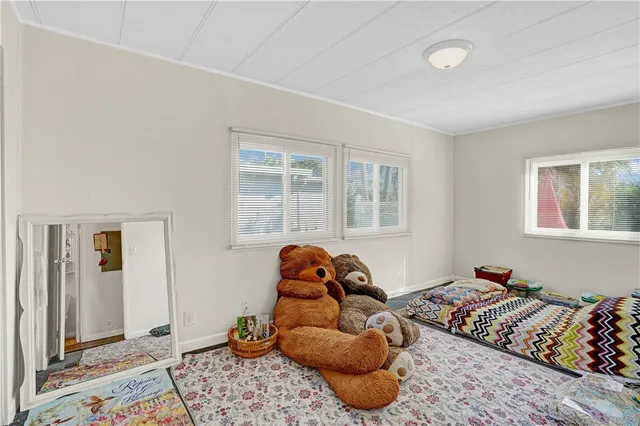 a bedroom with bed and a window