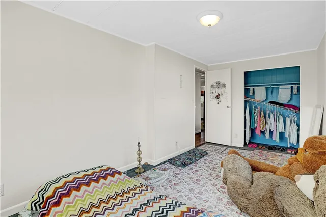 a bedroom with a bed and a book shelf