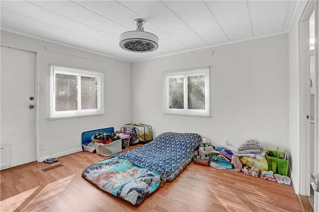 a bed sitting in a bedroom next to a window