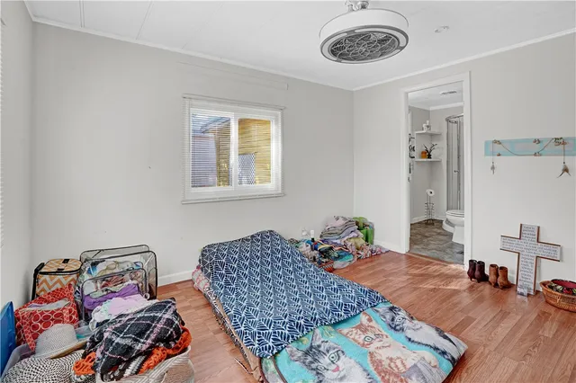 a bedroom with bed and a window