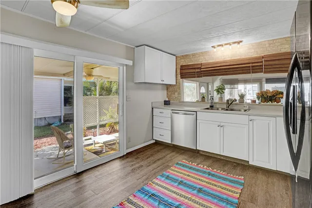a kitchen with a sink cabinets and wooden floor