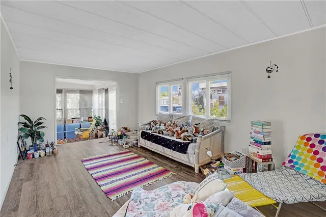a bed room with furniture and a potted plant
