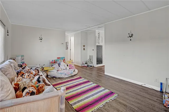 a bedroom with furniture and a wooden floor