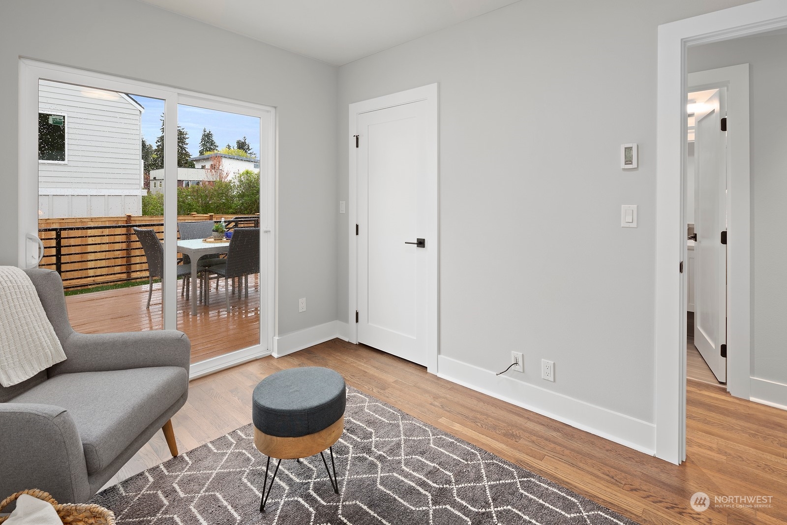 8510 Wallingford Avenue North, Unit A Seattle, WA 98103 - Photo 15 of 36 a living room with furniture and a wooden floor