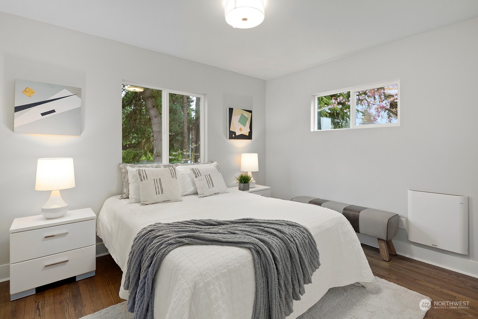 8510 Wallingford Avenue North, Unit A Seattle, WA 98103 - Photo 16 of 36 a bedroom with a bed and a lamp on dresser