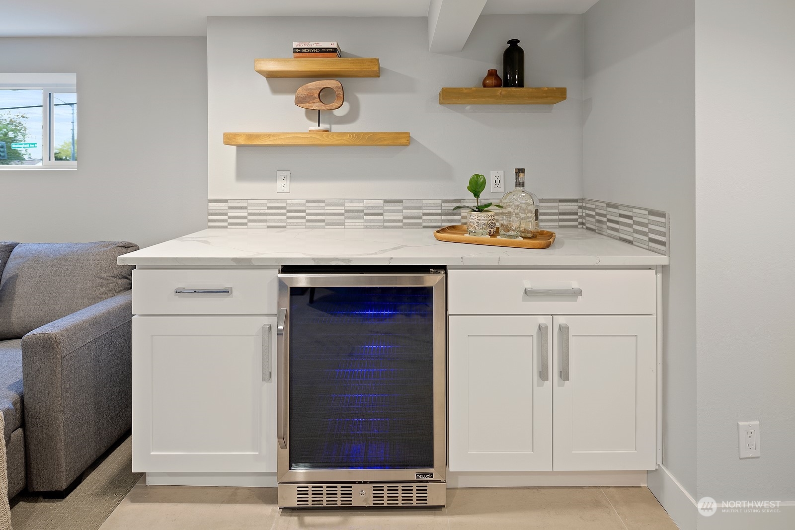 8510 Wallingford Avenue North, Unit A Seattle, WA 98103 - Photo 26 of 36 a kitchen with a sink cabinets and a wooden floor