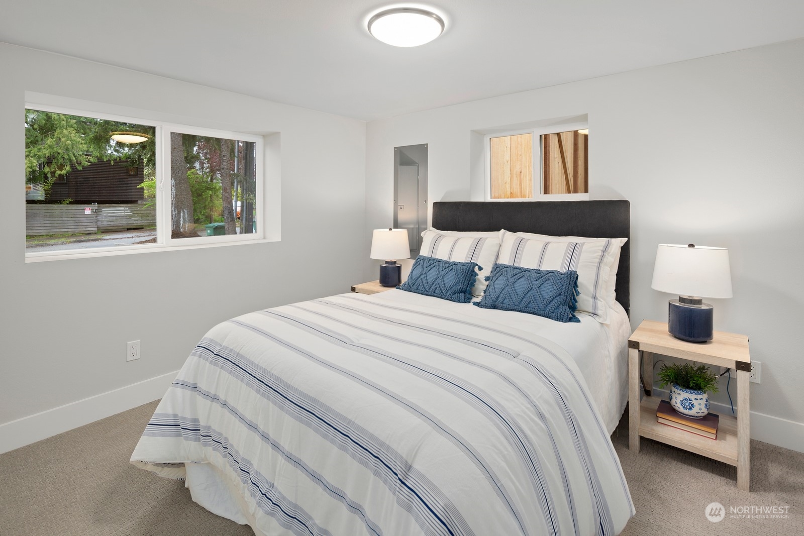 8510 Wallingford Avenue North, Unit A Seattle, WA 98103 - Photo 27 of 36 a bedroom with a bed and window