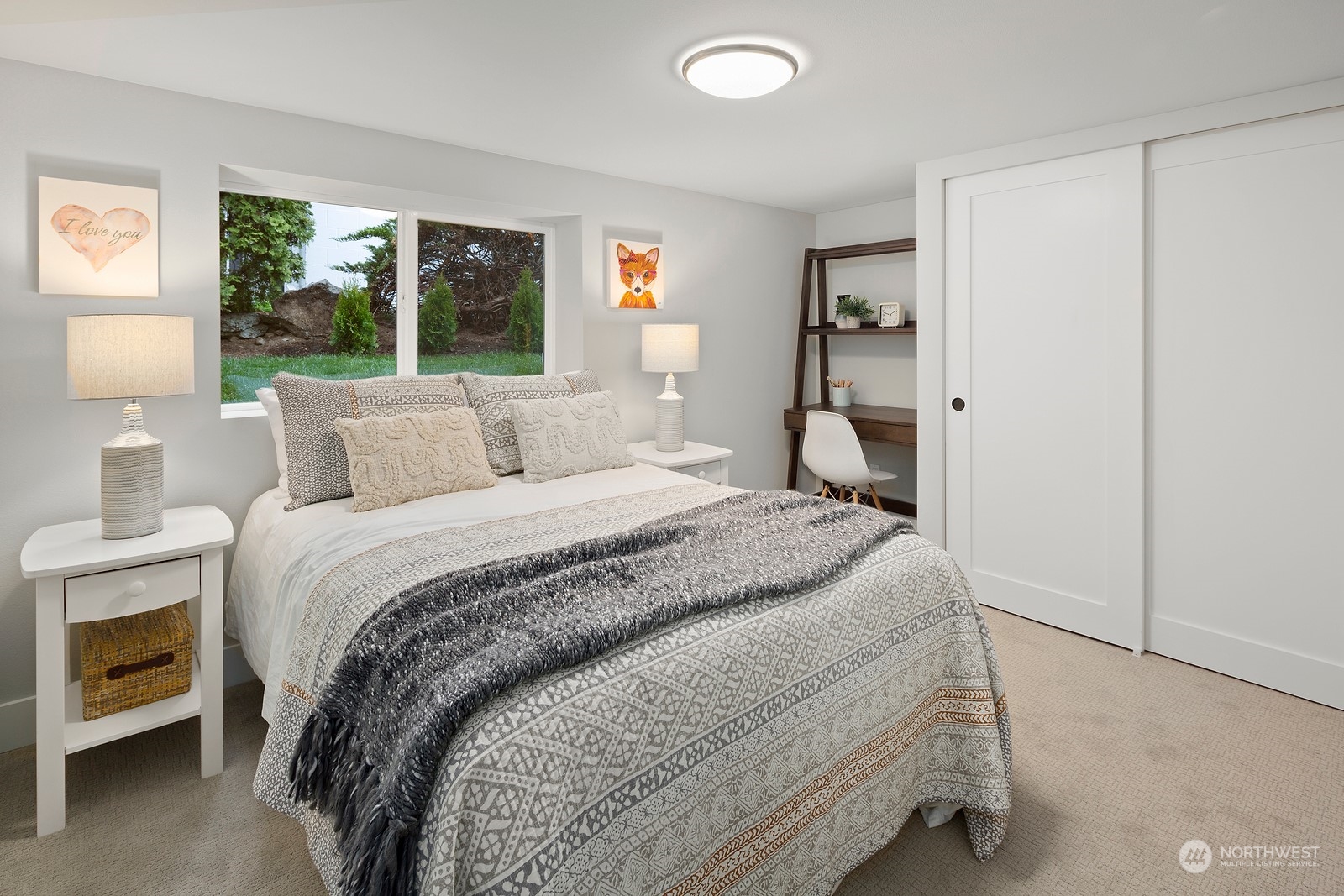 8510 Wallingford Avenue North, Unit A Seattle, WA 98103 - Photo 32 of 36 a bedroom with a bed and a large window