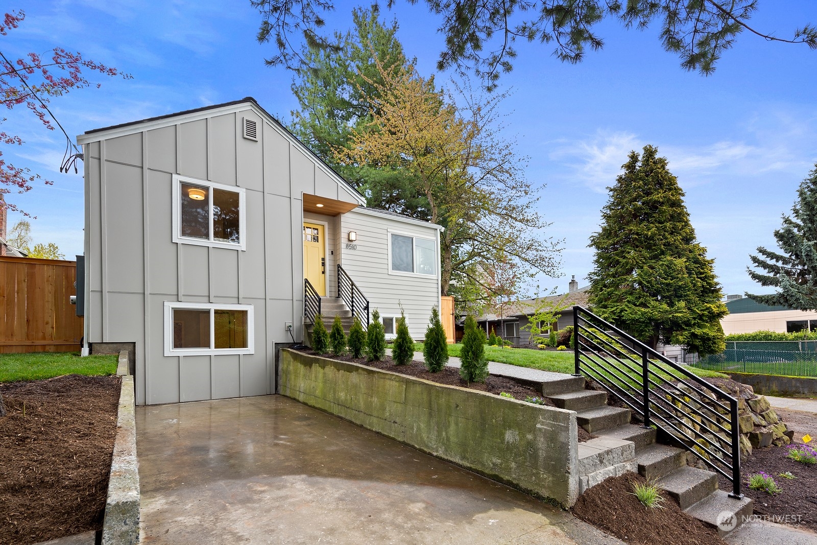 8510 Wallingford Avenue North, Unit A Seattle, WA 98103 - Photo 33 of 36 a view of house with a yard and potted plants