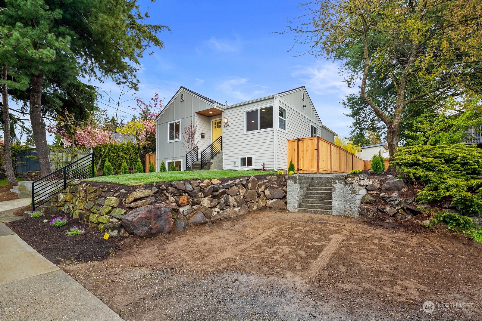 8510 Wallingford Avenue North, Unit A Seattle, WA 98103 - Photo 34 of 36 a front view of a house with a yard
