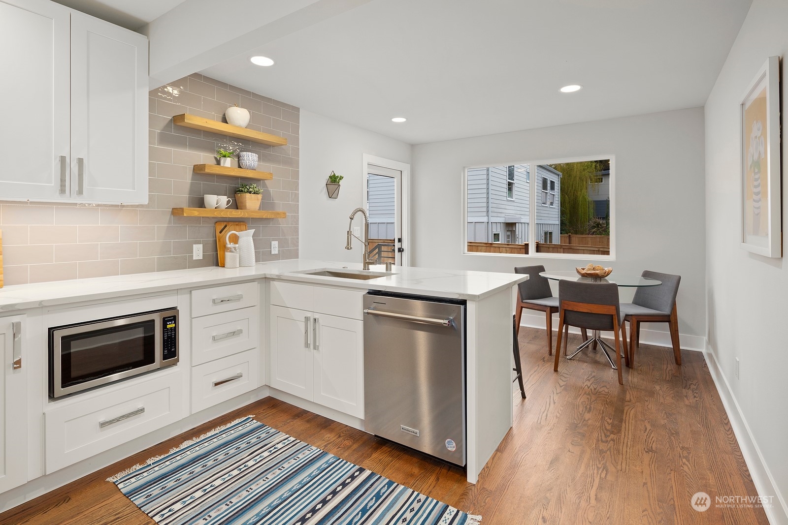 8510 Wallingford Avenue North, Unit A Seattle, WA 98103 - Photo 7 of 36 a kitchen with a sink stove and cabinets