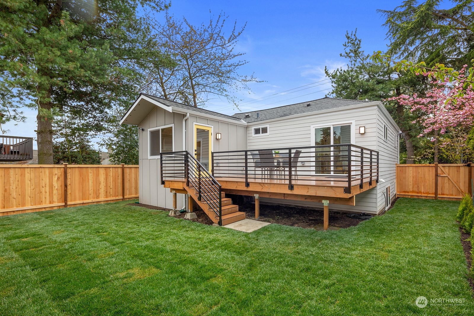8510 Wallingford Avenue North, Unit A Seattle, WA 98103 - Photo 10 of 36 a backyard of a house with wooden deck and barbeque oven