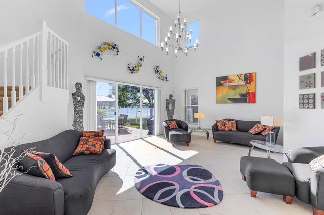 a large kitchen with stainless steel appliances kitchen island granite countertop a sink and chairs