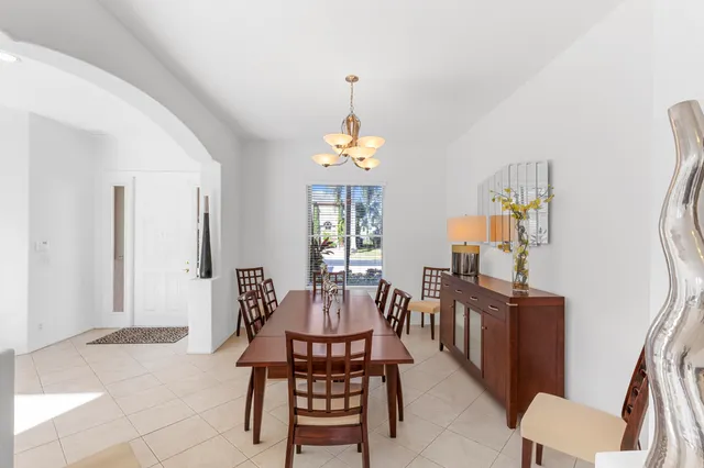 a bedroom with furniture and a large window