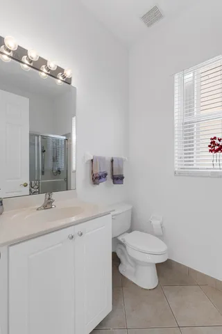 a spacious bathroom with a double vanity sink a mirror a bathtub and a shower