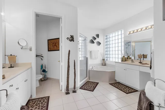 a spacious bedroom with a bed and a cabinets