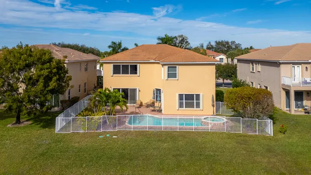 an aerial view of a house with a yard and balcony