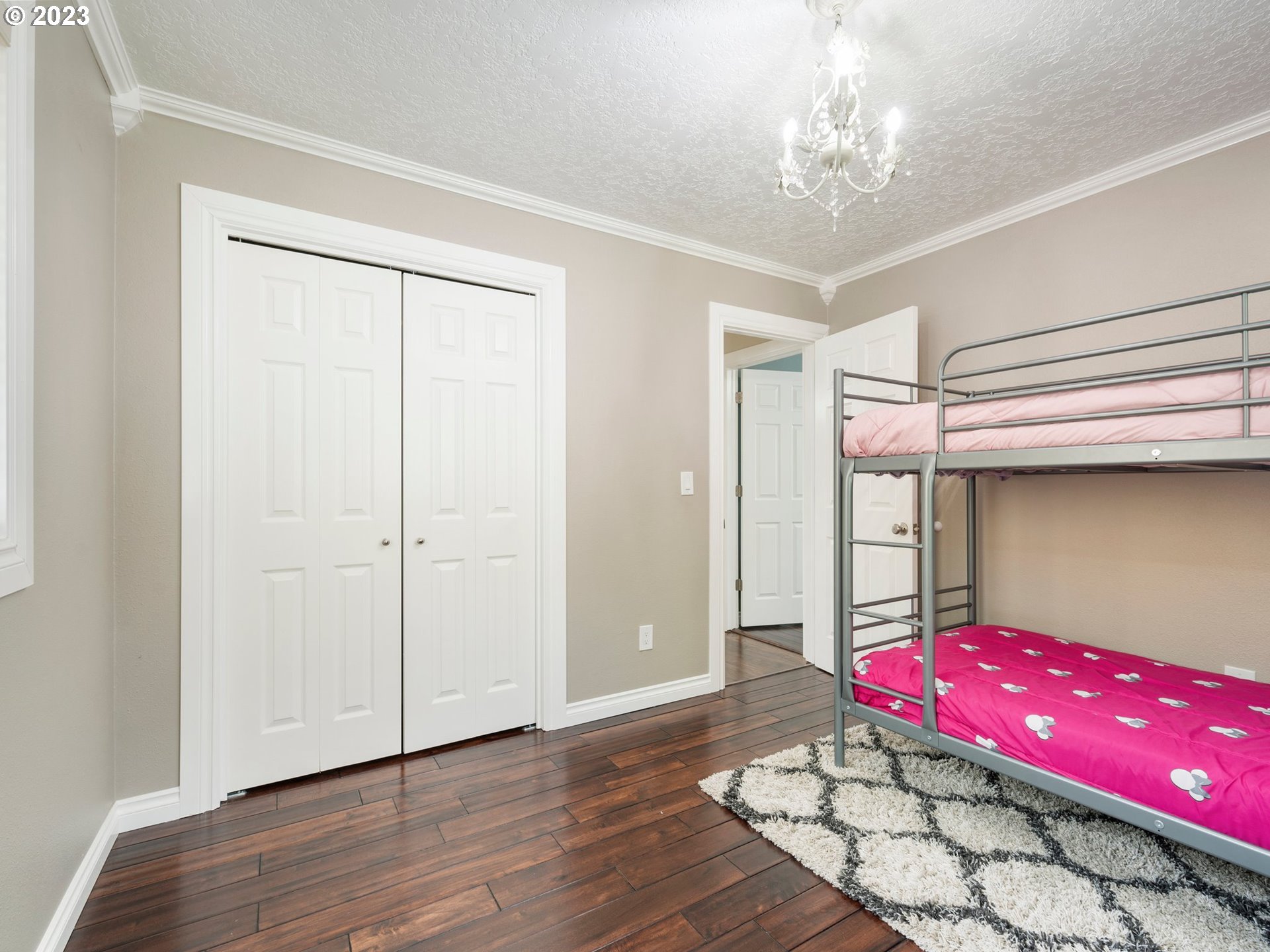 65353 East Timberline Drive Rhododendron, OR 97049 - Photo 20 of 34 a bedroom with a bed and a chandelier